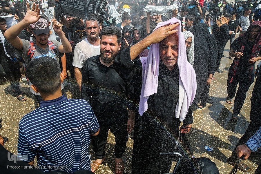 Pilgrims escape heat in Najaf, Iraq, on September 11, 2022